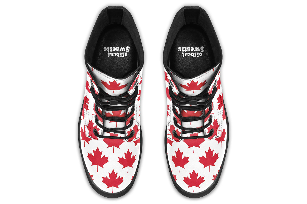 White boots with red maple leaf patterns all over it