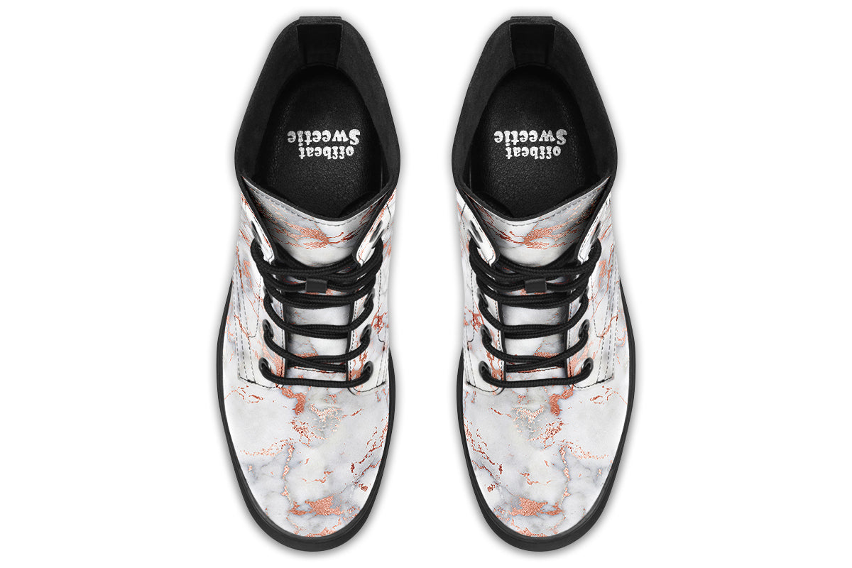 Boots featuring a grey marble-like pattern with accents of blush pink throughout the marble design