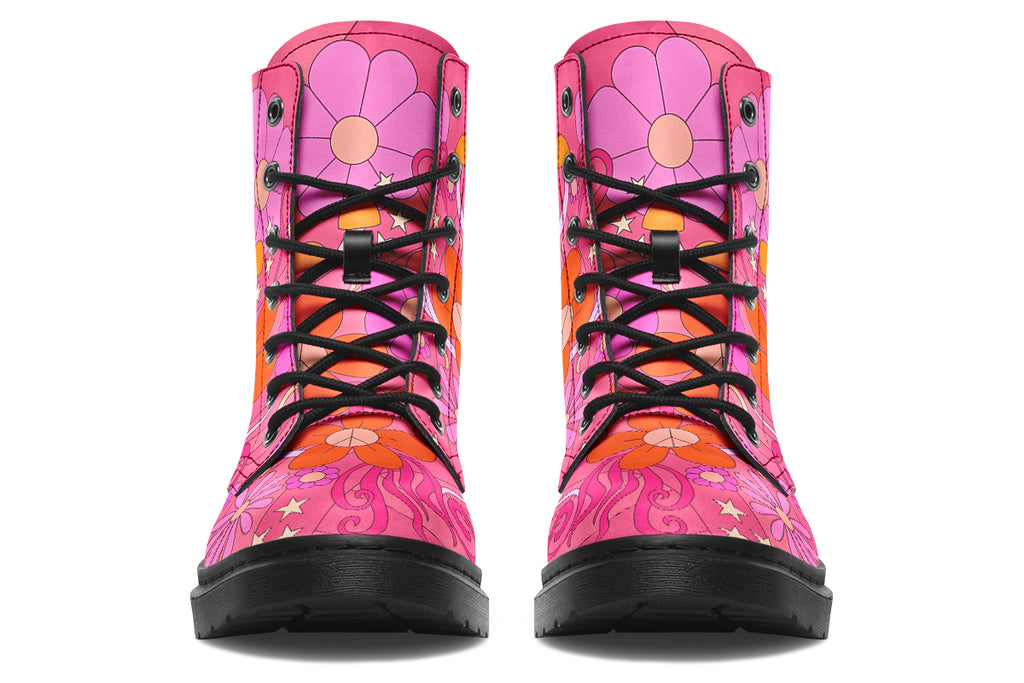 Pink boots with a black sole. Pattern shows midcentury retro-style daisies and decorative swirls.