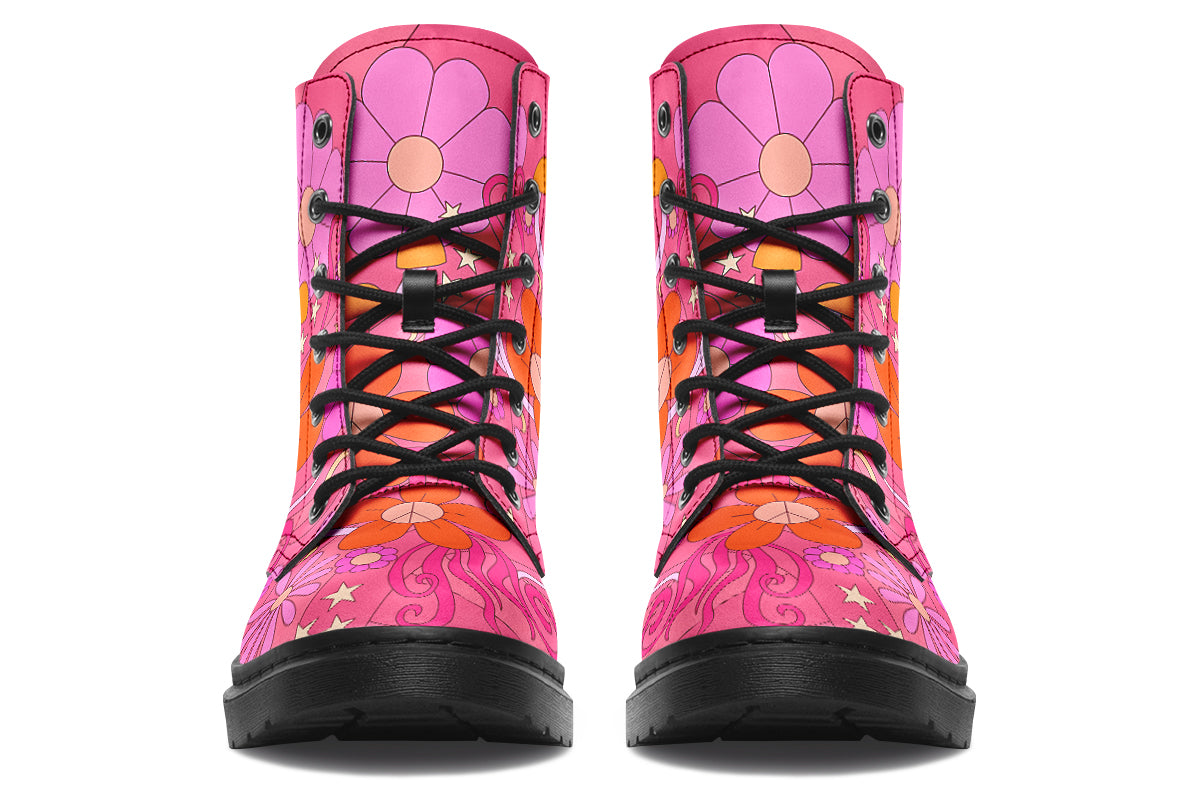 Pink boots with a black sole. Pattern shows midcentury retro-style daisies and decorative swirls.
