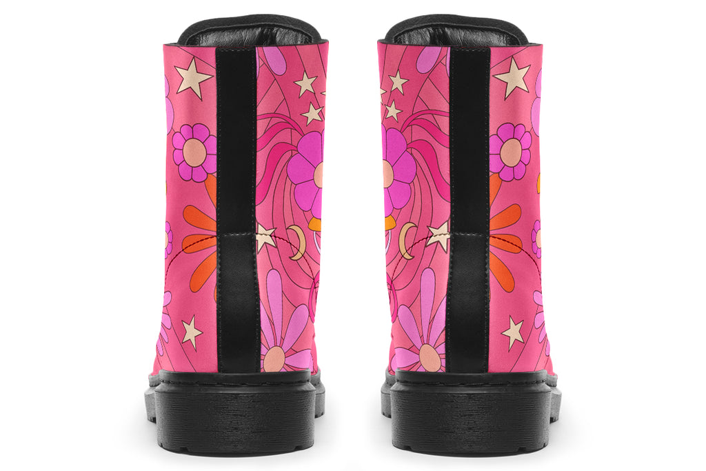 Pink boots with a black sole. Pattern shows midcentury retro-style daisies and decorative swirls.
