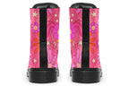 Pink boots with a black sole. Pattern shows midcentury retro-style daisies and decorative swirls.