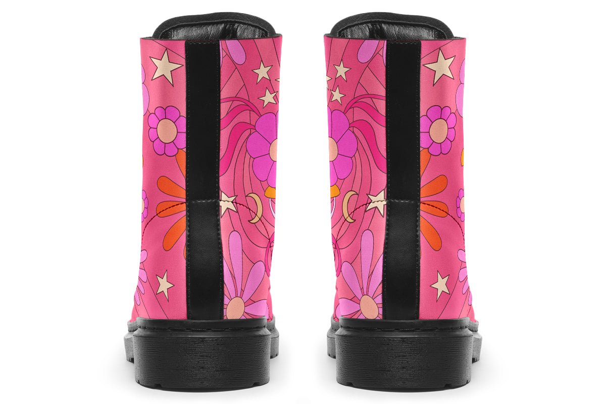Pink boots with a black sole. Pattern shows midcentury retro-style daisies and decorative swirls.