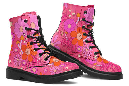 Pink boots with a black sole. Pattern shows midcentury retro-style daisies and decorative swirls.