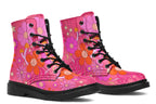 Pink boots with a black sole. Pattern shows midcentury retro-style daisies and decorative swirls.