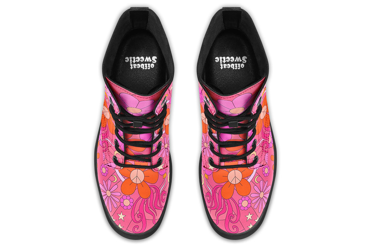 Pink boots with a black sole. Pattern shows midcentury retro-style daisies and decorative swirls.