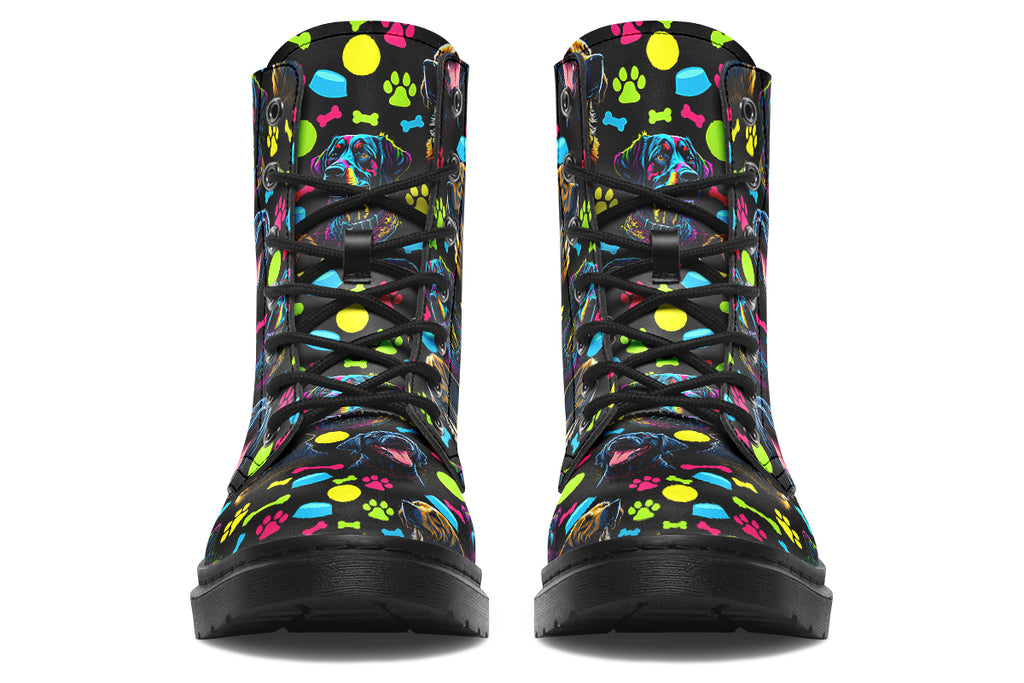Black boots with a repetitive pattern of dog faces and neon paw prints, dog bowls and dog bones.
