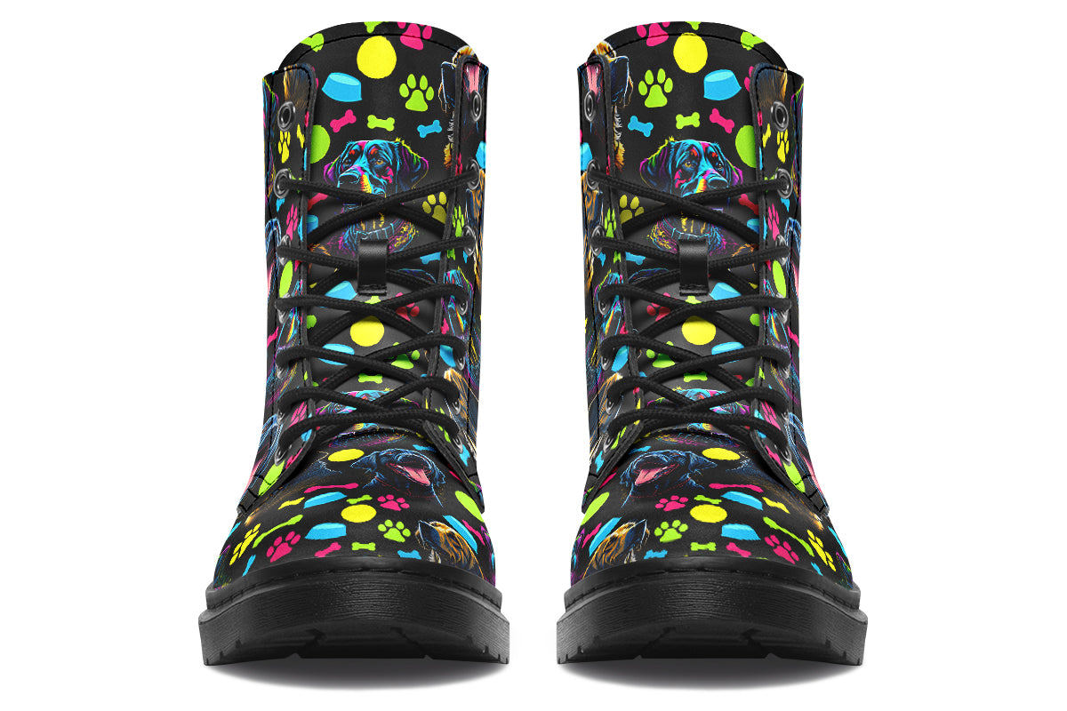 Black boots with a repetitive pattern of dog faces and neon paw prints, dog bowls and dog bones.