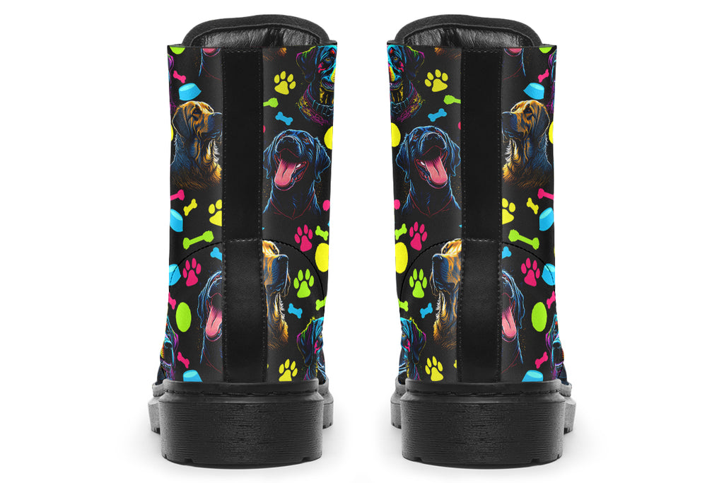 Black boots with a repetitive pattern of dog faces and neon paw prints, dog bowls and dog bones.