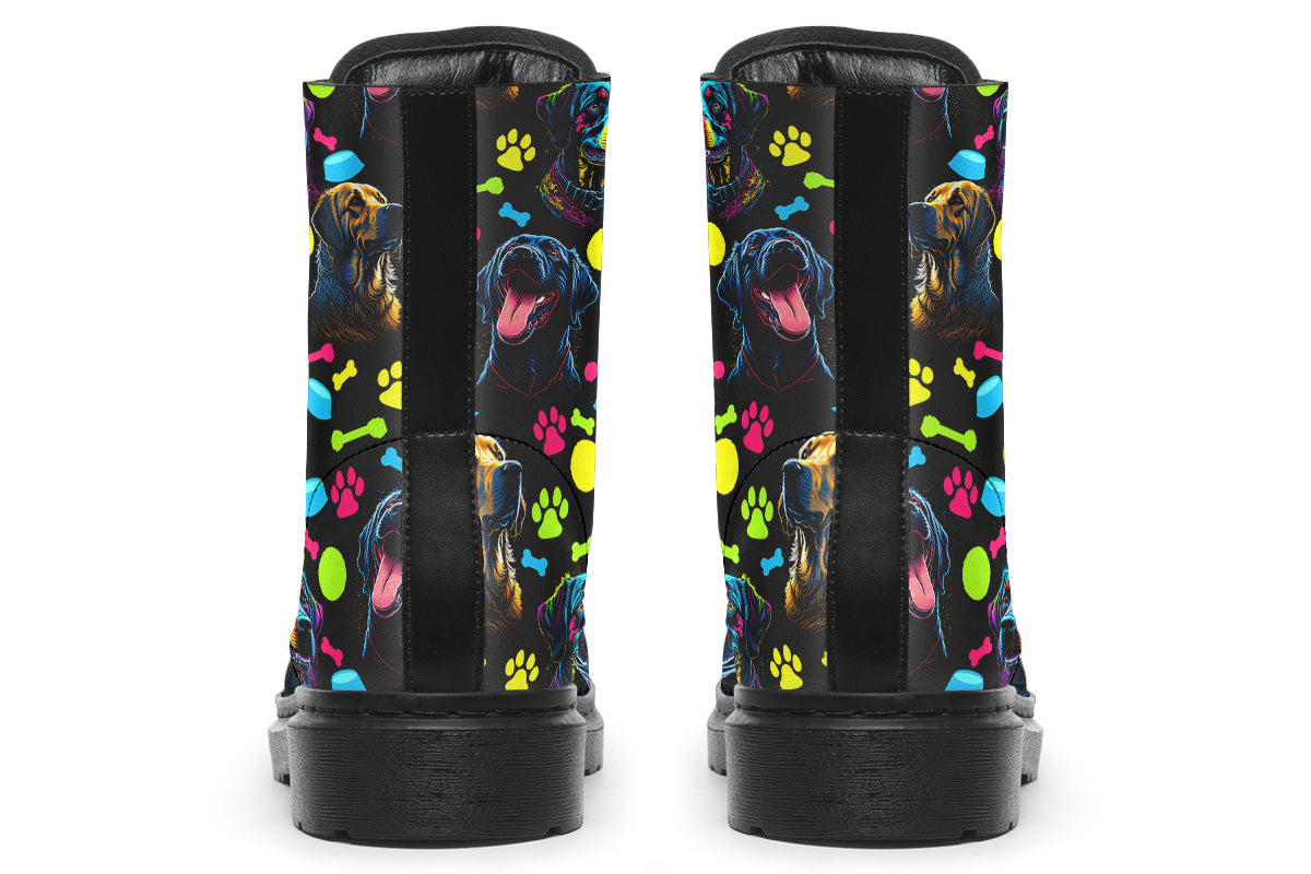 Black boots with a repetitive pattern of dog faces and neon paw prints, dog bowls and dog bones.