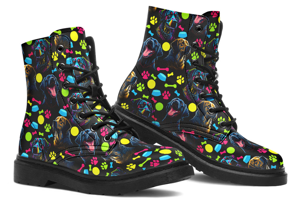 Black boots with a repetitive pattern of dog faces and neon paw prints, dog bowls and dog bones.