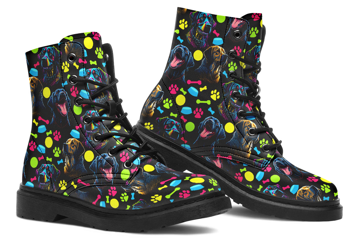 Black boots with a repetitive pattern of dog faces and neon paw prints, dog bowls and dog bones.