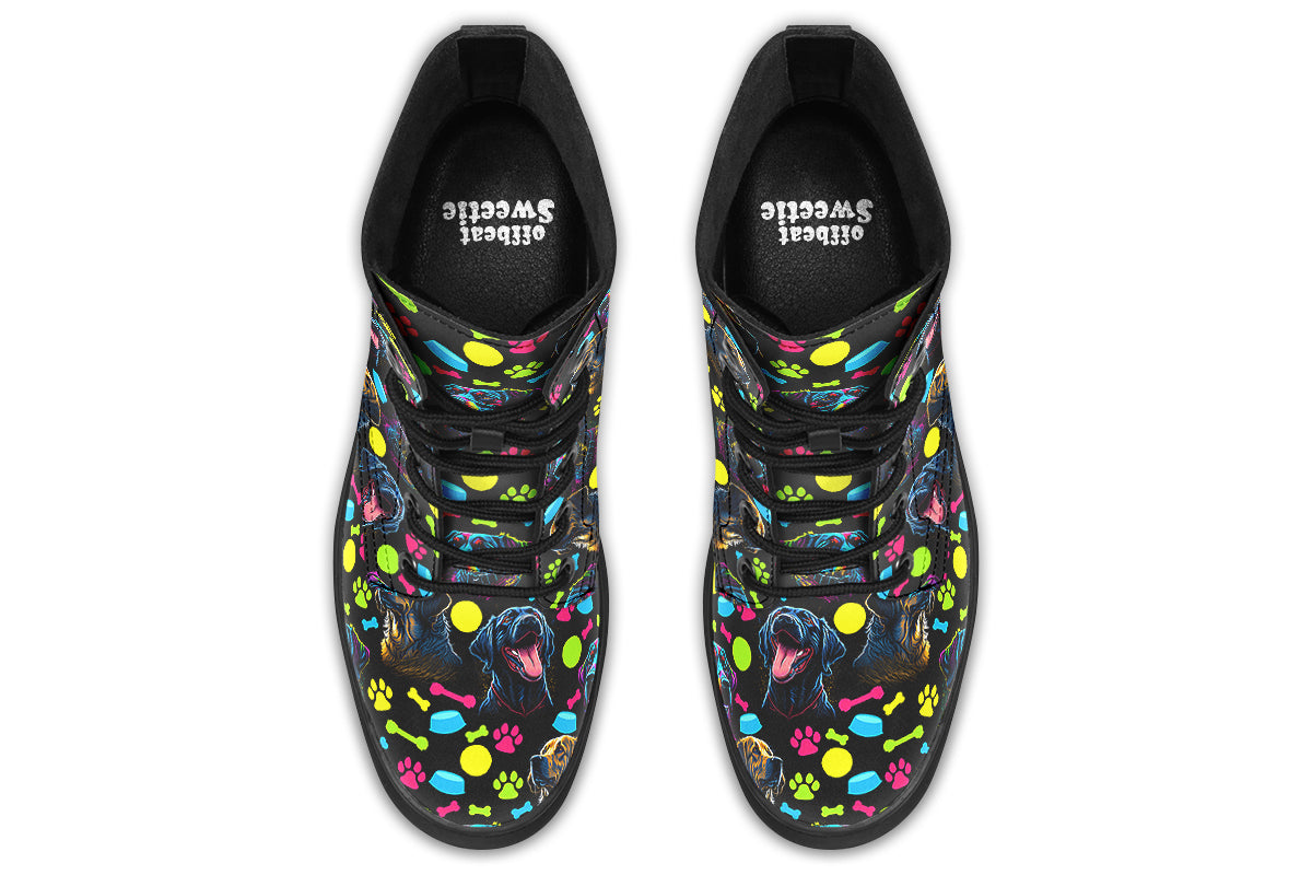 Black boots with a repetitive pattern of dog faces and neon paw prints, dog bowls and dog bones.
