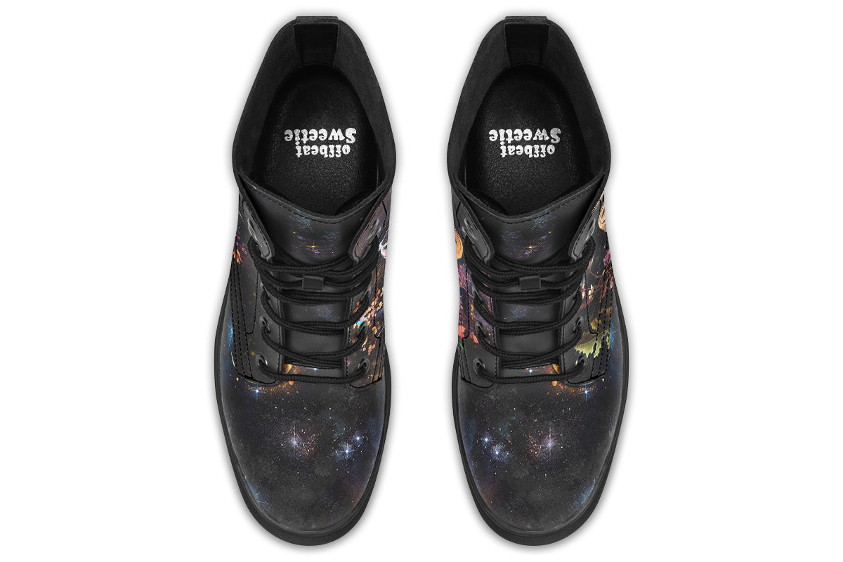 Black boots with different owls on each side.