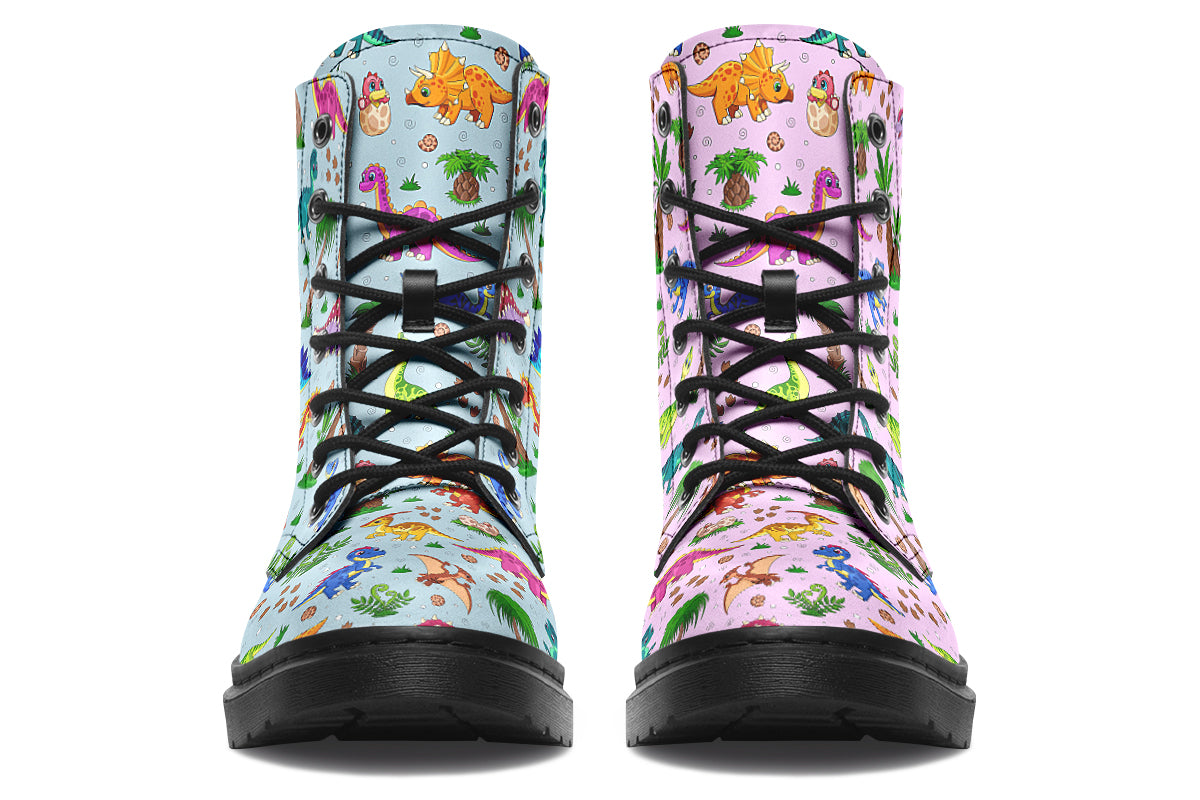 Mismatched boots, one light blue, one light pink, each with a pattern of different coloured cute baby dinosaurs, prehistoric-looking trees and dinosaur eggs