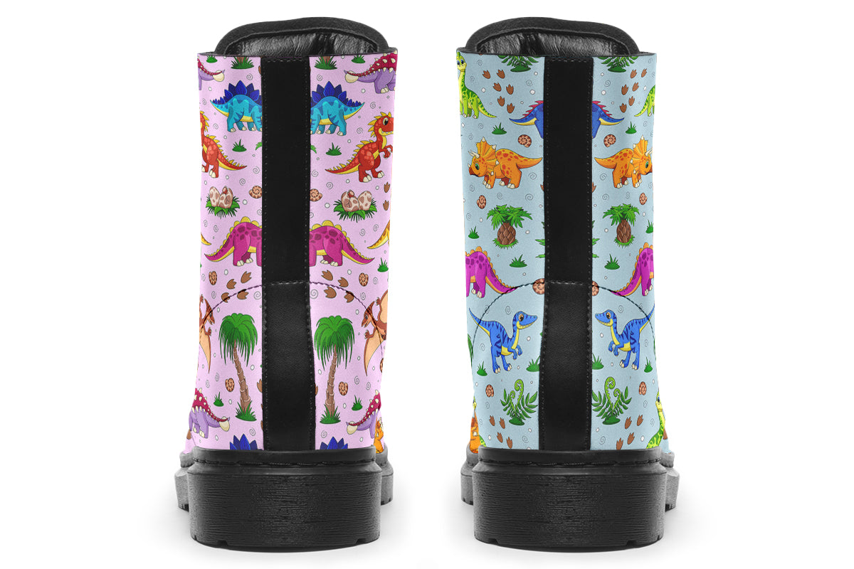 Mismatched boots, one light blue, one light pink, each with a pattern of different coloured cute baby dinosaurs, prehistoric-looking trees and dinosaur eggs