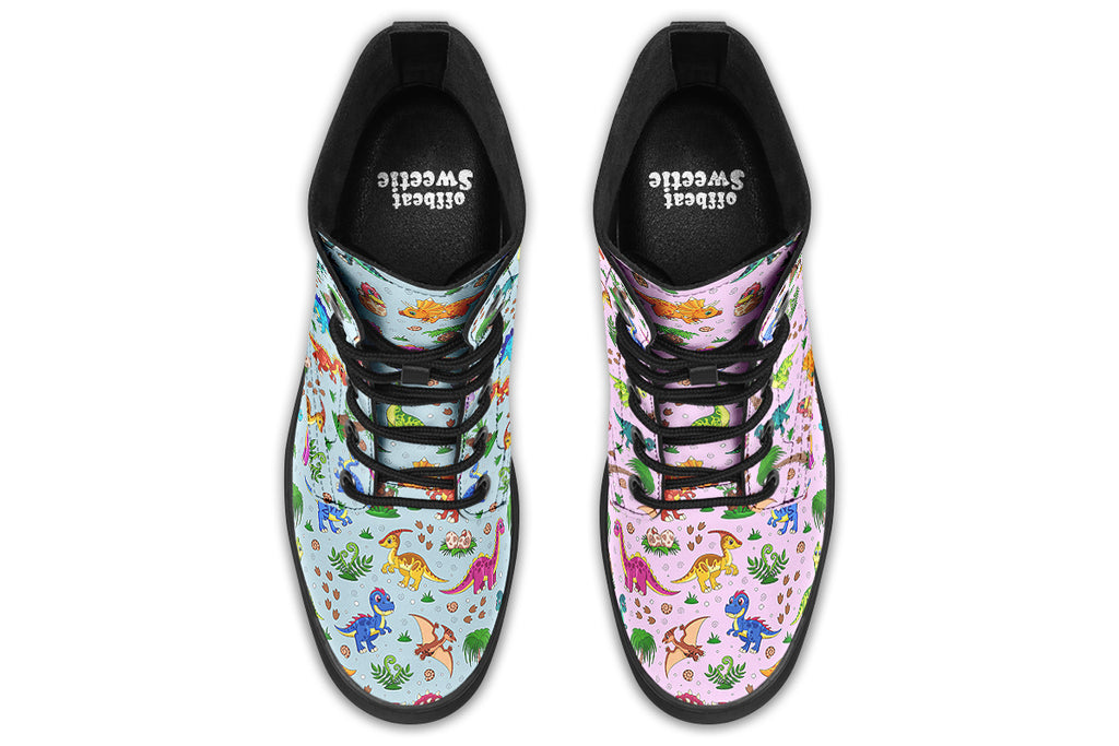 Mismatched boots, one light blue, one light pink, each with a pattern of different coloured cute baby dinosaurs, prehistoric-looking trees and dinosaur eggs