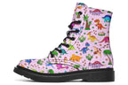 Light pink boots with a pattern of different coloured cute baby dinosaurs, prehistoric-looking trees and dinosaur eggs