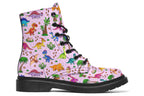 Light pink boots with a pattern of different coloured cute baby dinosaurs, prehistoric-looking trees and dinosaur eggs