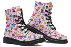 Light pink boots with a pattern of different coloured cute baby dinosaurs, prehistoric-looking trees and dinosaur eggs