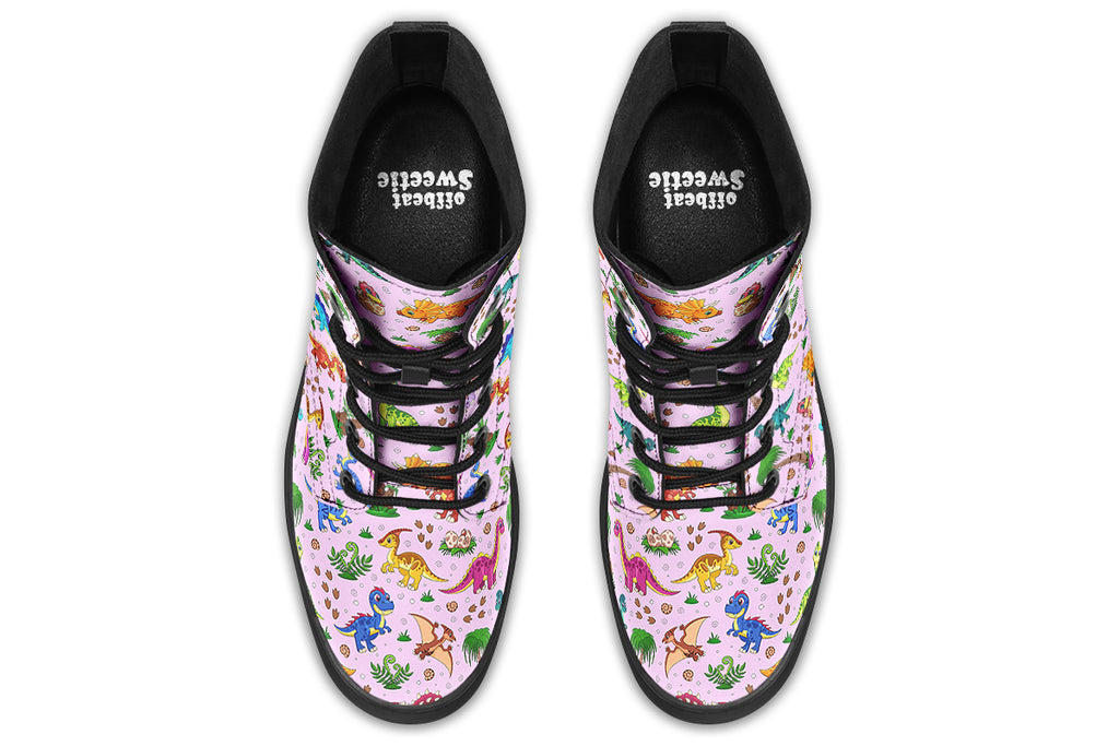 Light pink boots with a pattern of different coloured cute baby dinosaurs, prehistoric-looking trees and dinosaur eggs