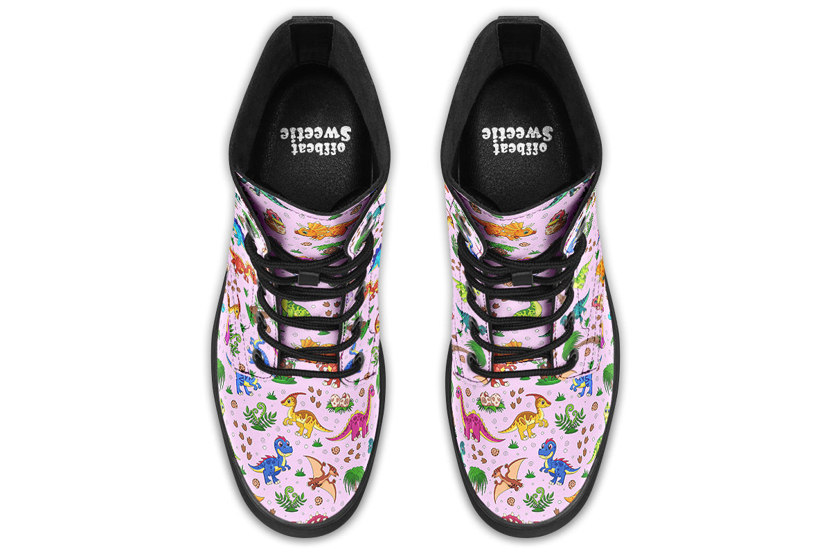 Light pink boots with a pattern of different coloured cute baby dinosaurs, prehistoric-looking trees and dinosaur eggs