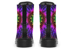 Boots featuring a vibrant, almost neon mandala pattern in a gradient of green, yellow, red, pink and purple on a black background.