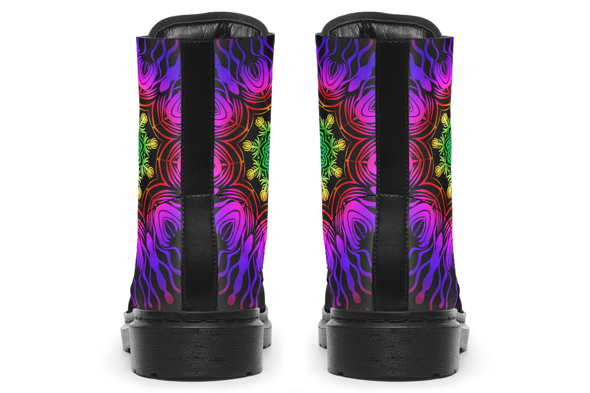 Boots featuring a vibrant, almost neon mandala pattern in a gradient of green, yellow, red, pink and purple on a black background.