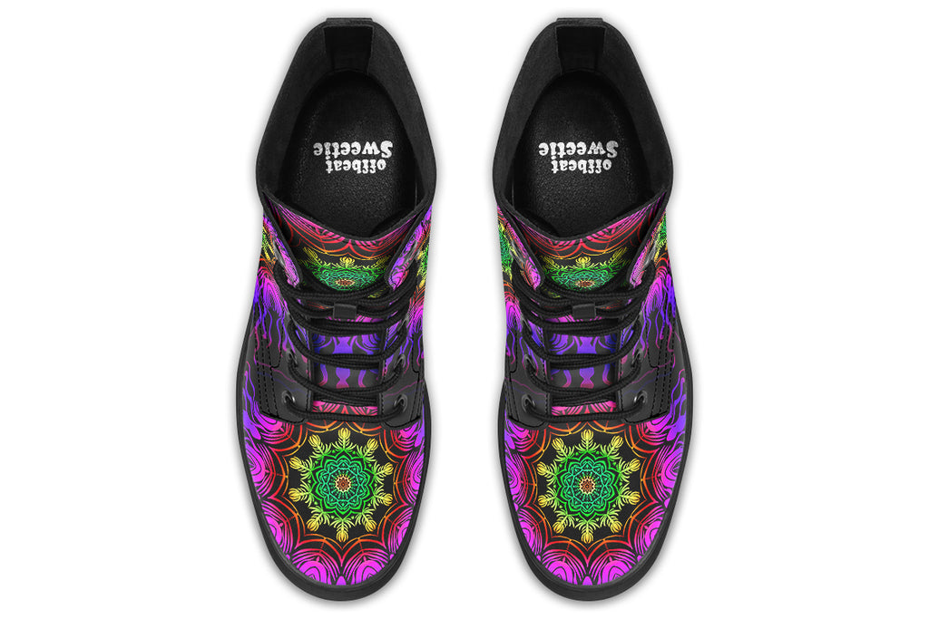 Boots featuring a vibrant, almost neon mandala pattern in a gradient of green, yellow, red, pink and purple on a black background.