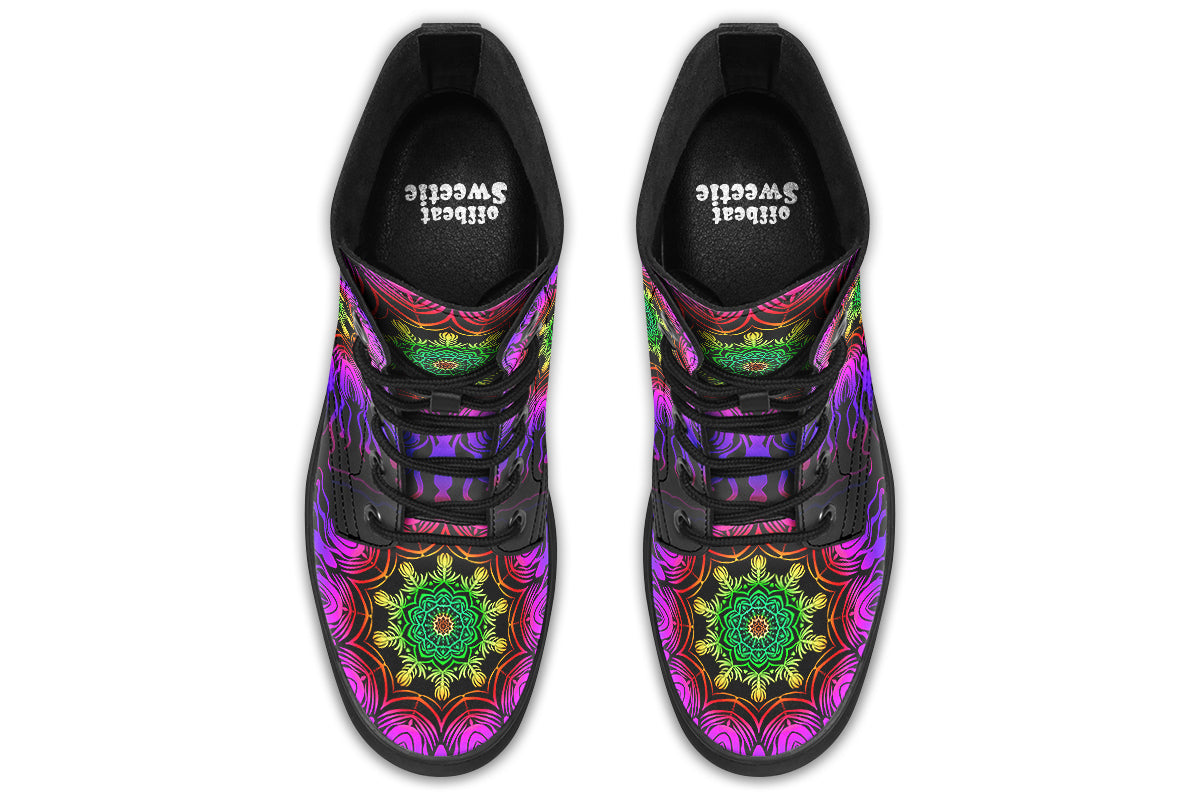 Boots featuring a vibrant, almost neon mandala pattern in a gradient of green, yellow, red, pink and purple on a black background.