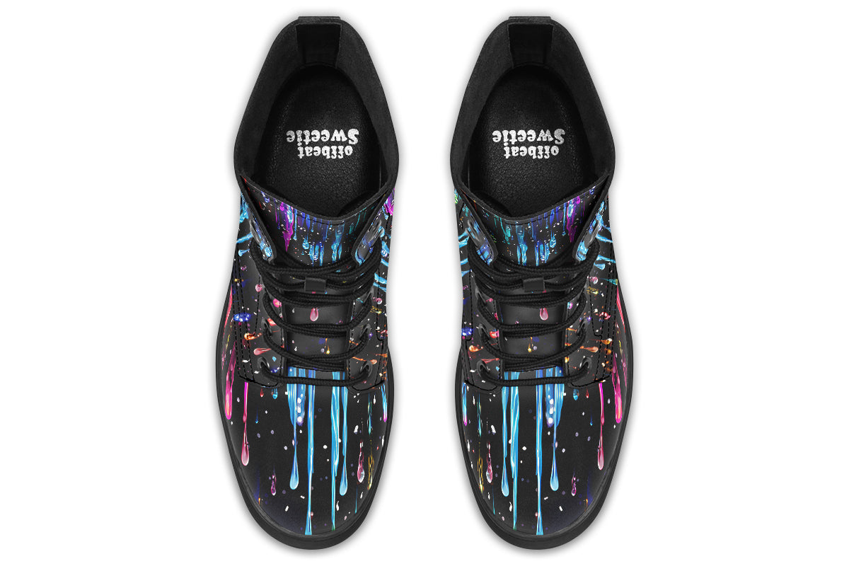 Black boots with a design that looks like different coloured paints dripping down the boots