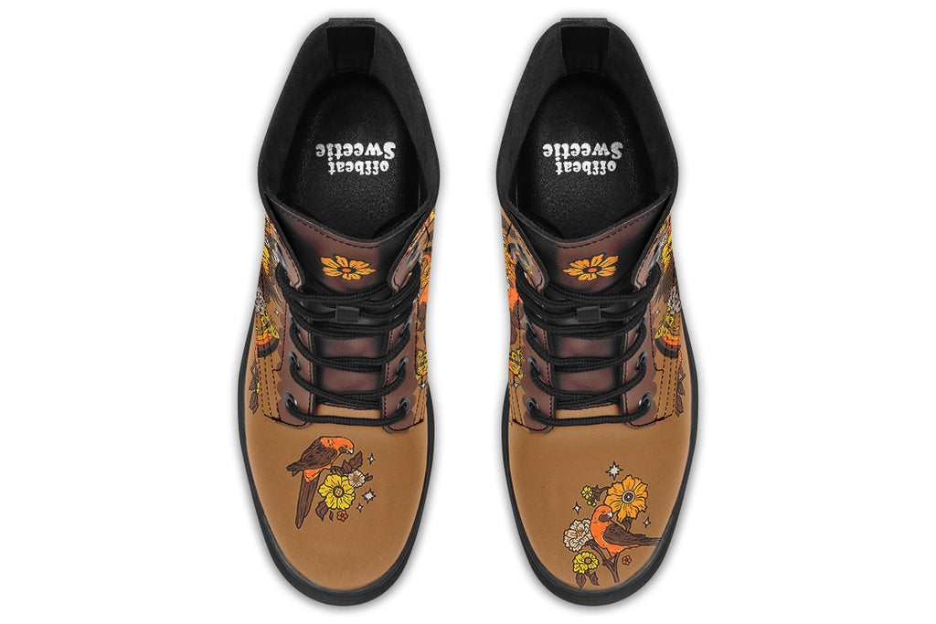 Tan brown boots with a rosella and floral design in retro colours of oranges, mustard yellows and browns. It features a patchwork pattern across the top of the boots.
