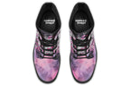 Purple and pink music-themed patterned boot with black sole. Design shows musical instruments, treble clefs, sheet music etc amongst decorative swirls.