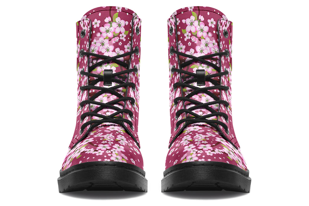 Boots featuring a pink and white floral pattern on a dark reddish pink background