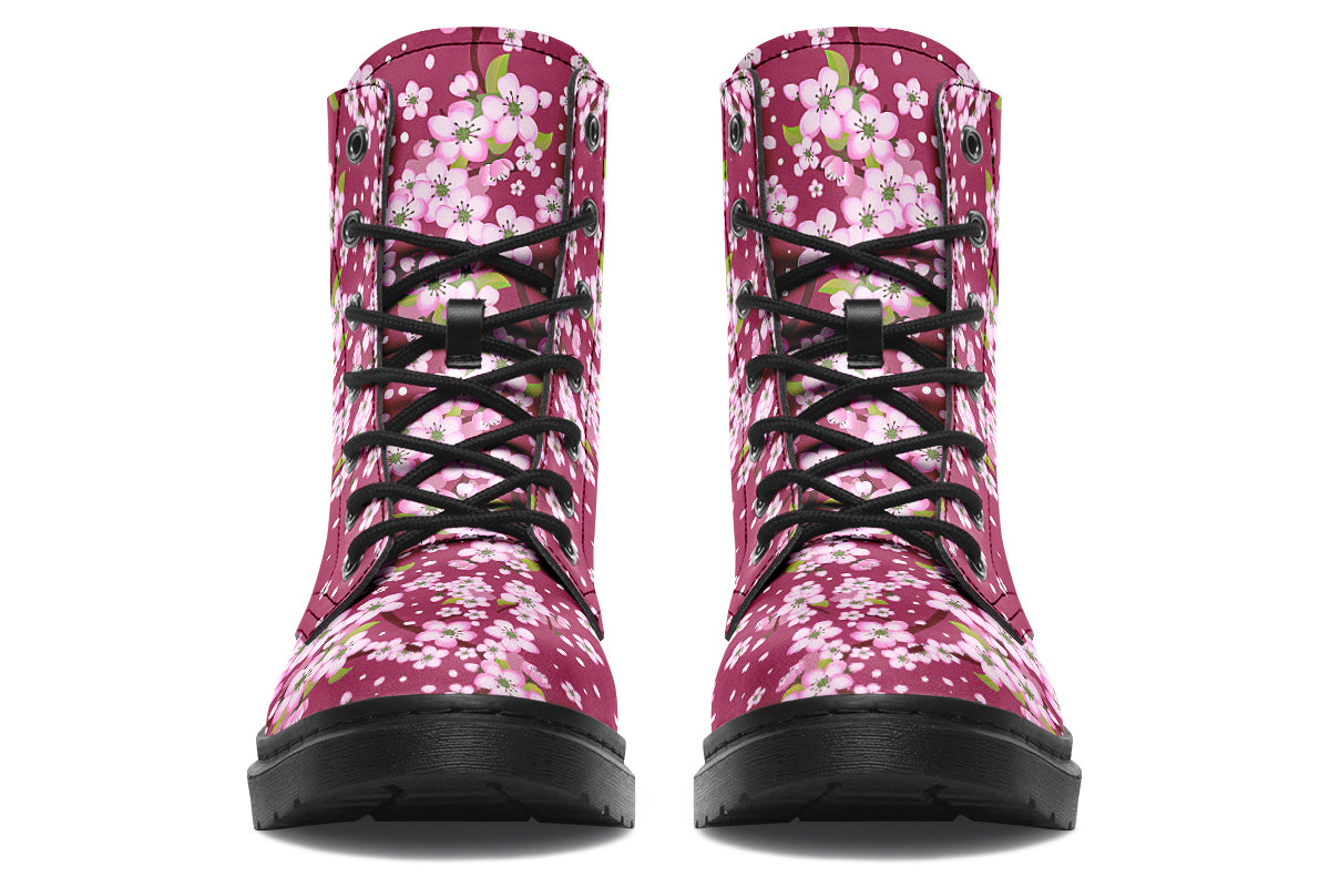 Boots featuring a pink and white floral pattern on a dark reddish pink background