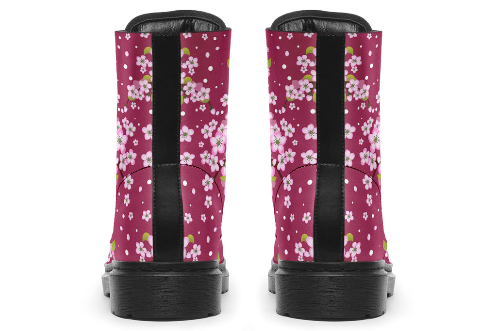 Boots featuring a pink and white floral pattern on a dark reddish pink background