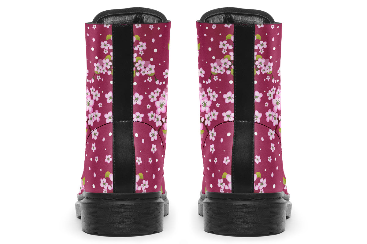 Boots featuring a pink and white floral pattern on a dark reddish pink background