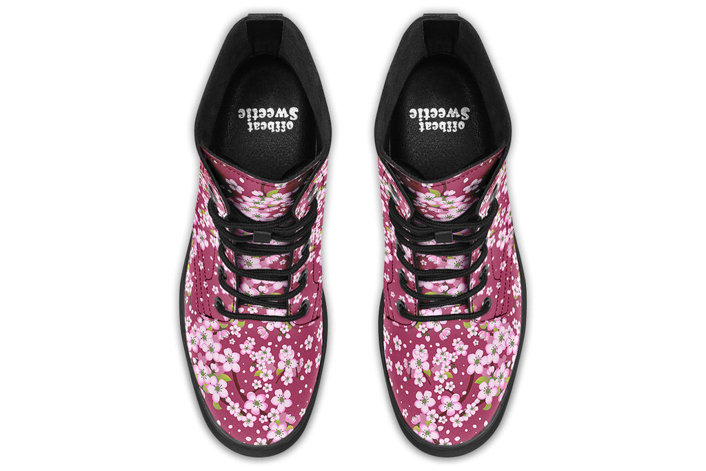 Boots featuring a pink and white floral pattern on a dark reddish pink background