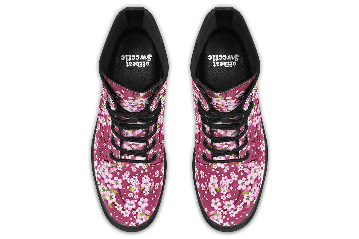 Boots featuring a pink and white floral pattern on a dark reddish pink background