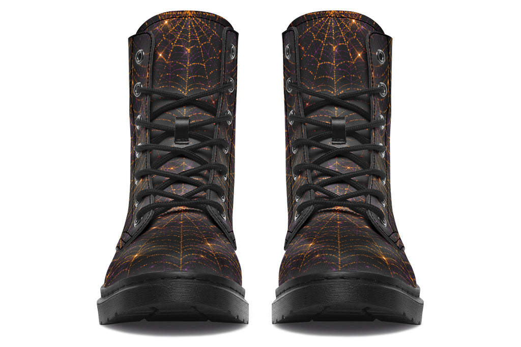 Very dark brown boots with bronze spiderweb patterns on them
