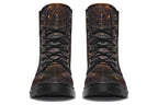 Very dark brown boots with bronze spiderweb patterns on them