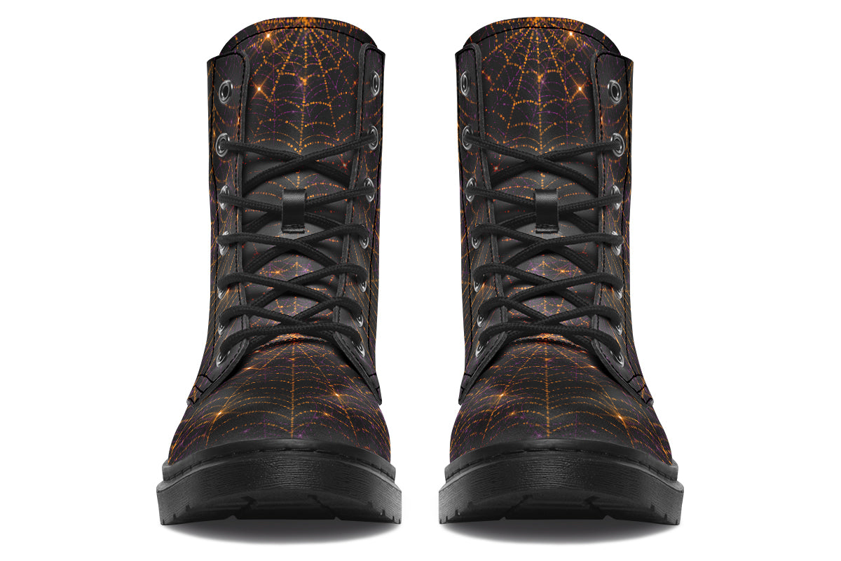 Very dark brown boots with bronze spiderweb patterns on them