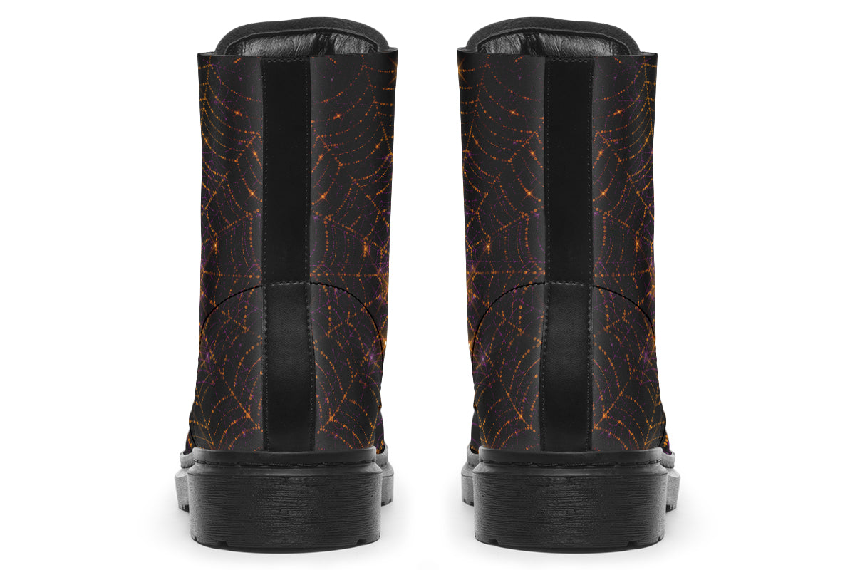 Very dark brown boots with bronze spiderweb patterns on them