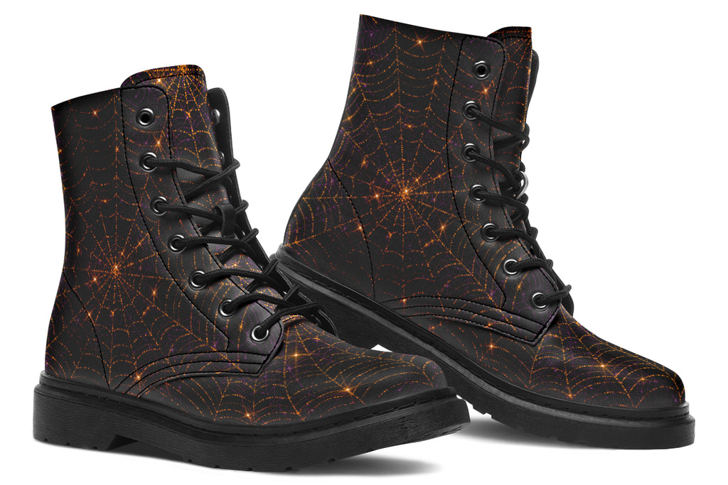 Very dark brown boots with bronze spiderweb patterns on them