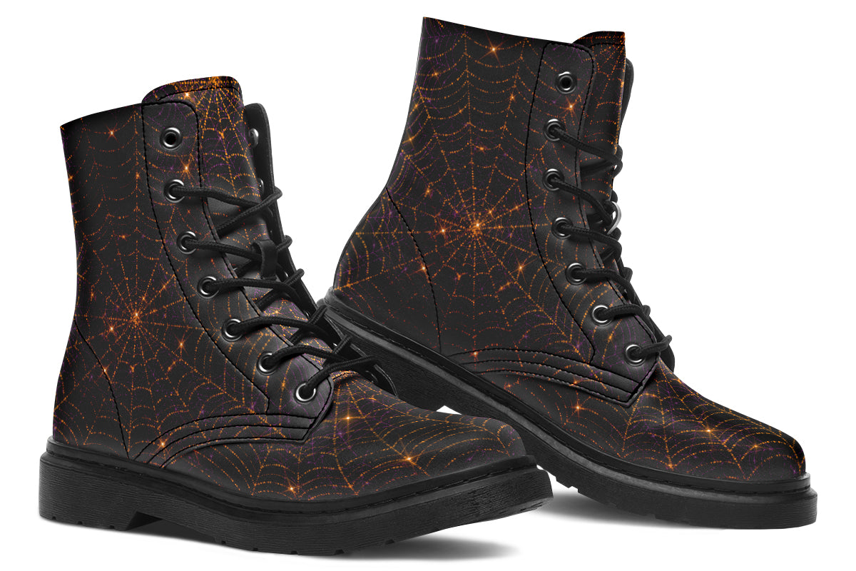 Very dark brown boots with bronze spiderweb patterns on them