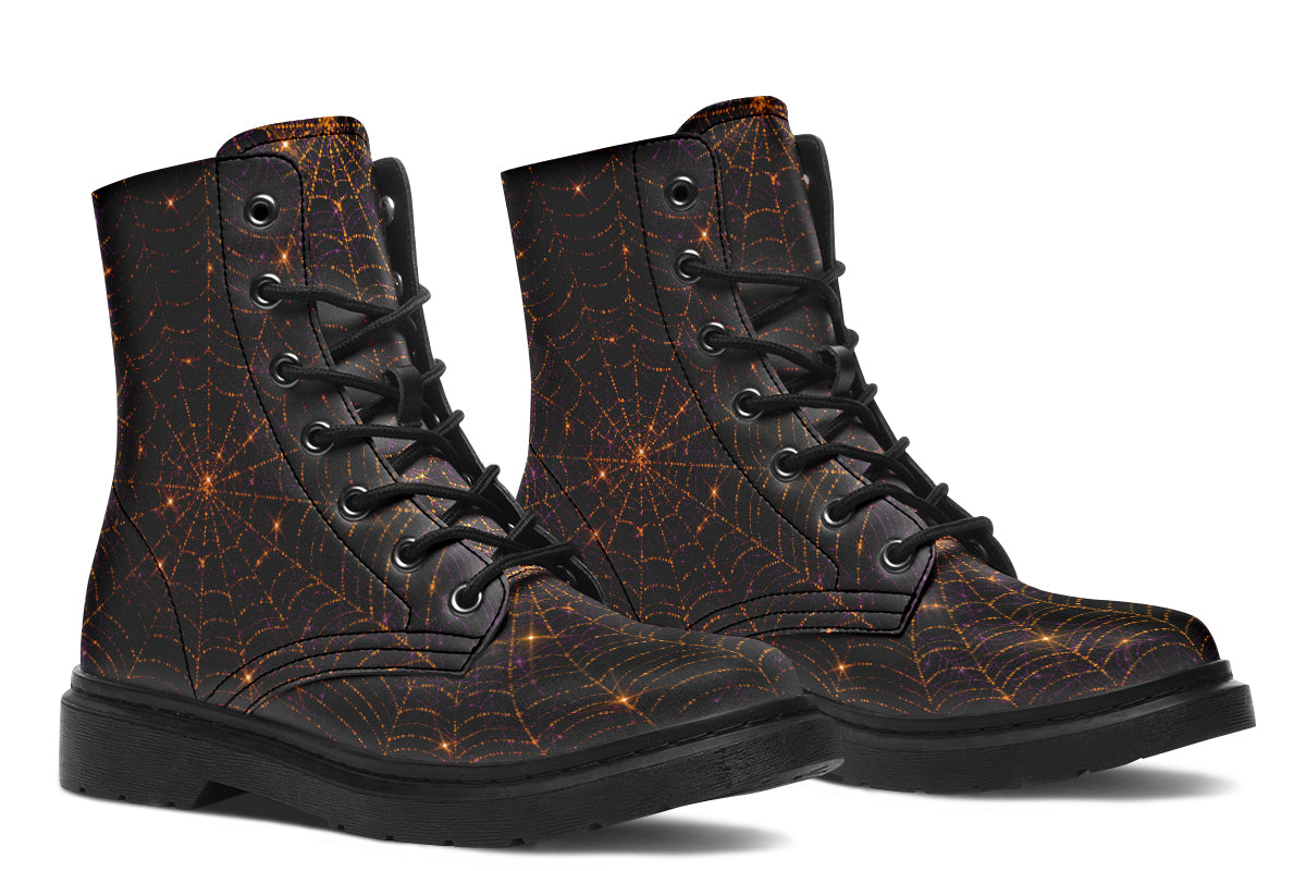Very dark brown boots with bronze spiderweb patterns on them