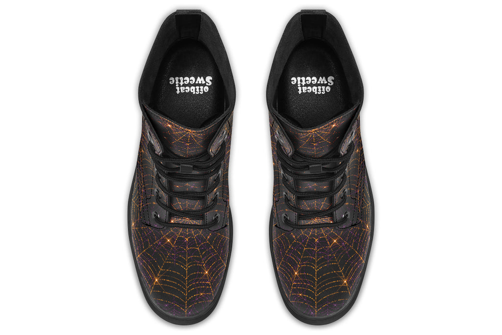 Very dark brown boots with bronze spiderweb patterns on them