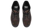 Very dark brown boots with bronze spiderweb patterns on them