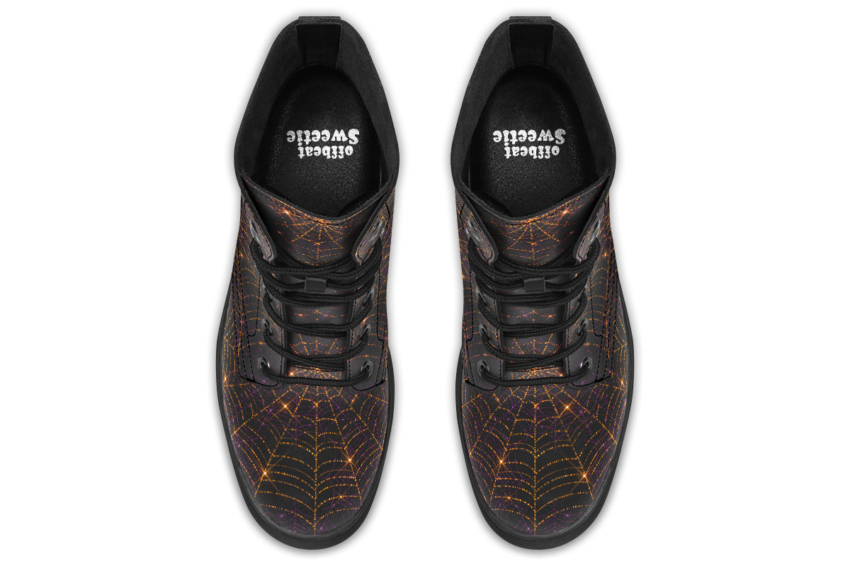 Very dark brown boots with bronze spiderweb patterns on them