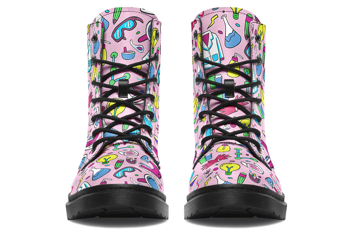 Pink boots featuring a pattern of various STEM icons, such as microscopes, lab coats, DNA helix, microscopes, gloves and beakers. 